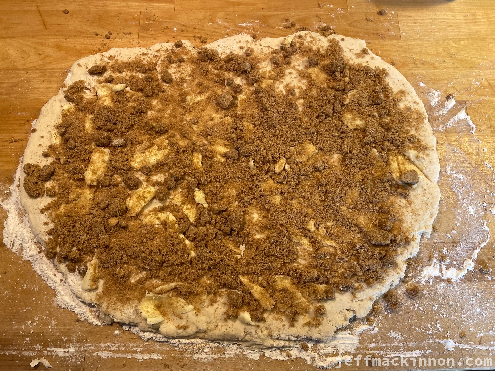 Rolled out dough with butter, sugar and cinnamon
