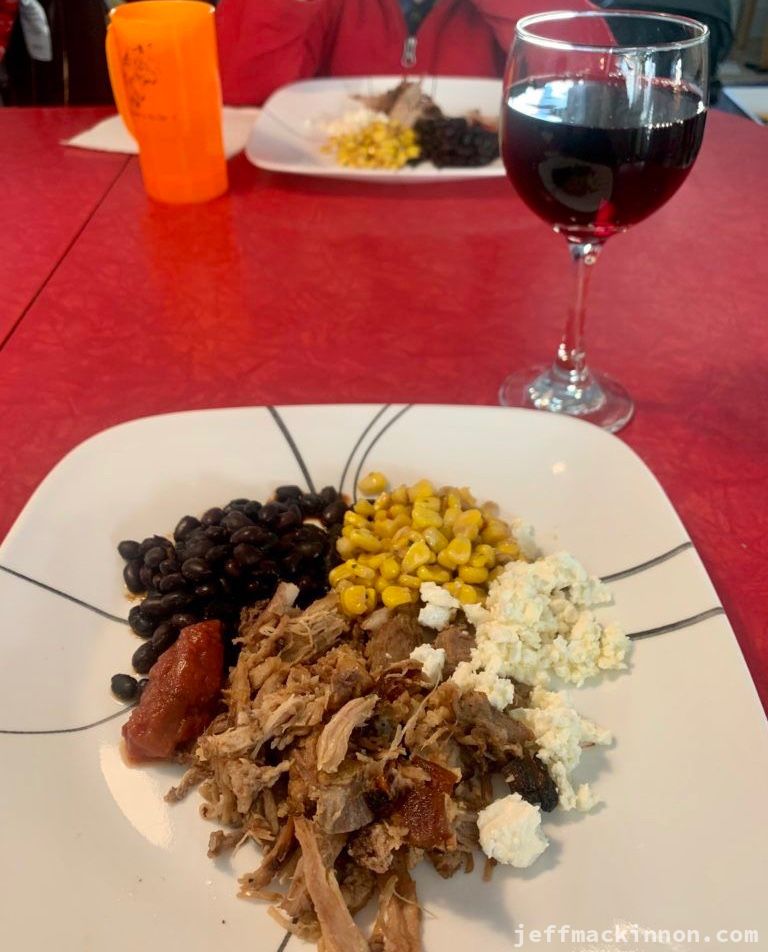 A plate of pulled pork with some fixins'