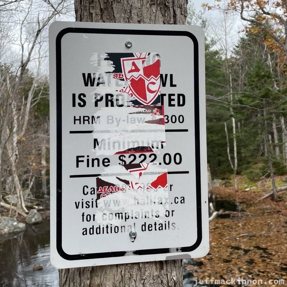 Weird stickers on a "Don't feed the wildlife" sign